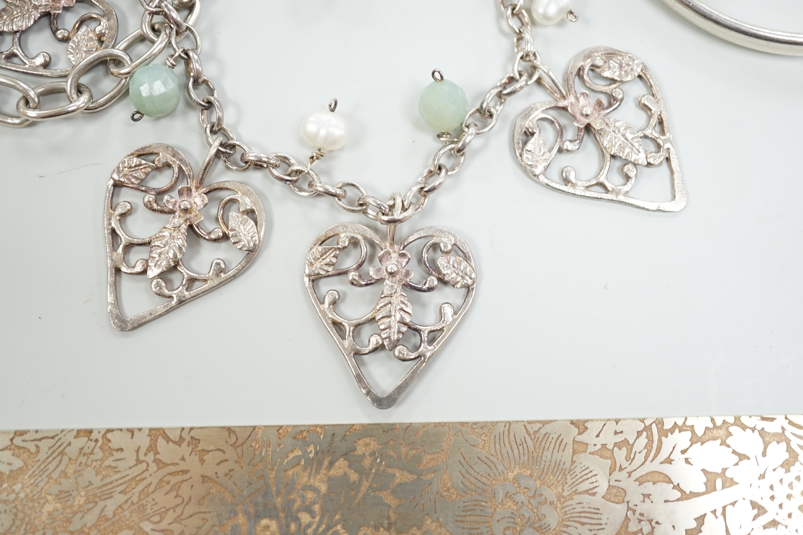 Three Pruden Smith bangles including triple loop, two other silver bangles, a white metal heart bracelet and one other bracelet, together with a straight edge rule by Mary Ann Simmons.